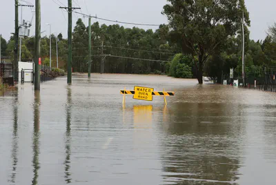 Photo by [Wes Warren](https://unsplash.com/@wcwarren) on [Unsplash](https://unsplash.com/photos/a-flooded-street-with-a-yellow-sign-eFzH4HGwcv4).